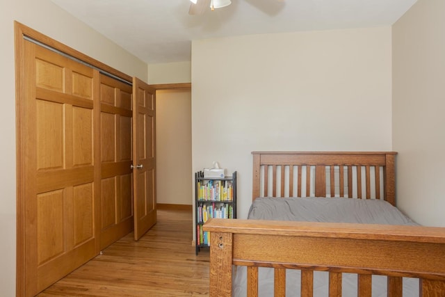 bedroom with light wood-style flooring and ceiling fan