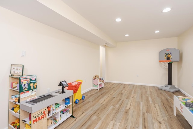 recreation room featuring recessed lighting, baseboards, and wood finished floors