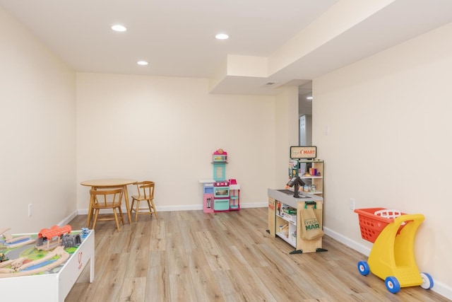 recreation room with recessed lighting, light wood-type flooring, baseboards, and visible vents