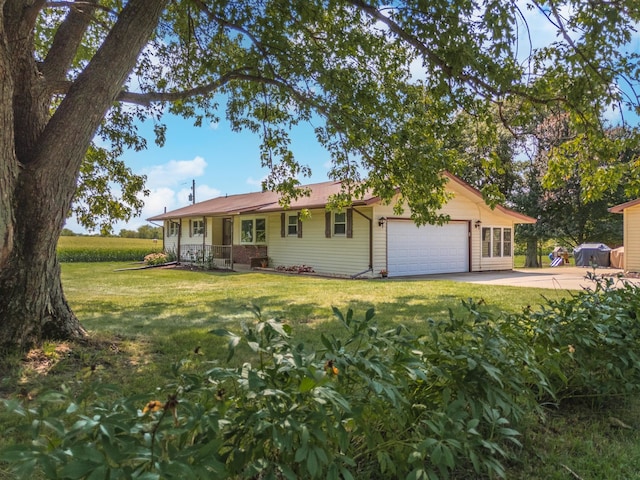 ranch-style house with an attached garage, concrete driveway, and a front yard