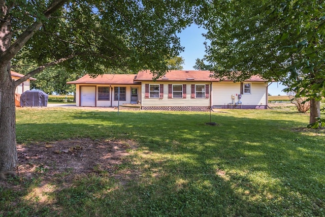 single story home featuring a front lawn and a garage