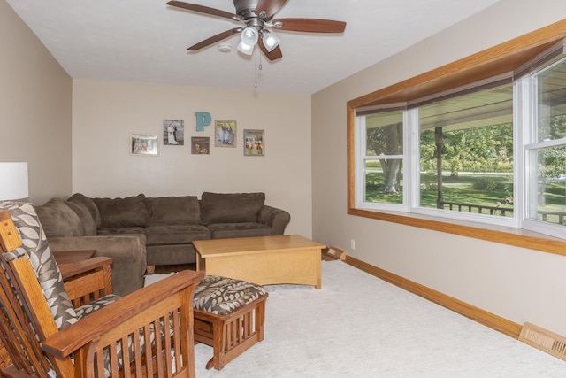 carpeted living area with baseboards, visible vents, and ceiling fan