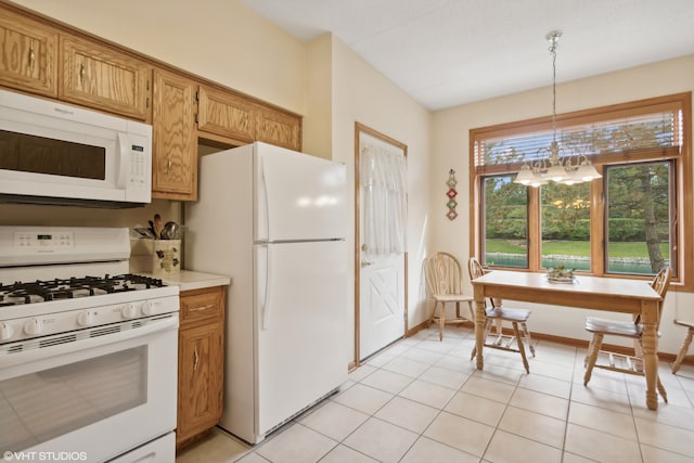 kitchen featuring pendant lighting, white appliances, a chandelier, and light tile patterned flooring