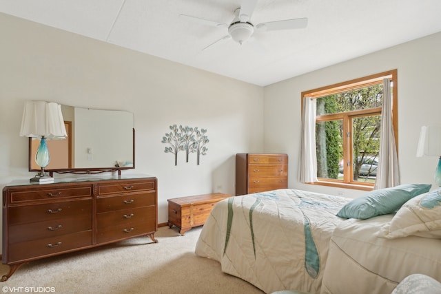 bedroom featuring ceiling fan and light carpet