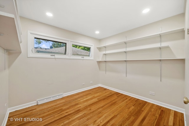 storage room featuring a baseboard heating unit