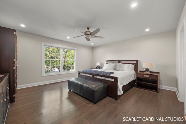 bedroom with ceiling fan and dark hardwood / wood-style floors