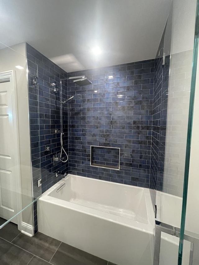 bathroom with tiled shower / bath and tile patterned floors