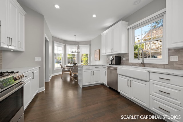 kitchen featuring white cabinetry, stainless steel appliances, and pendant lighting