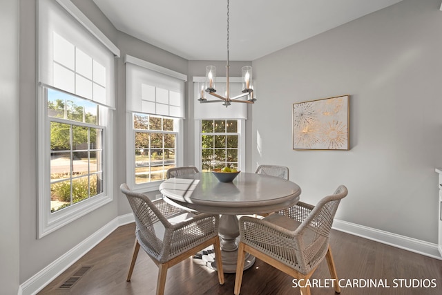 dining room featuring an inviting chandelier and dark hardwood / wood-style floors