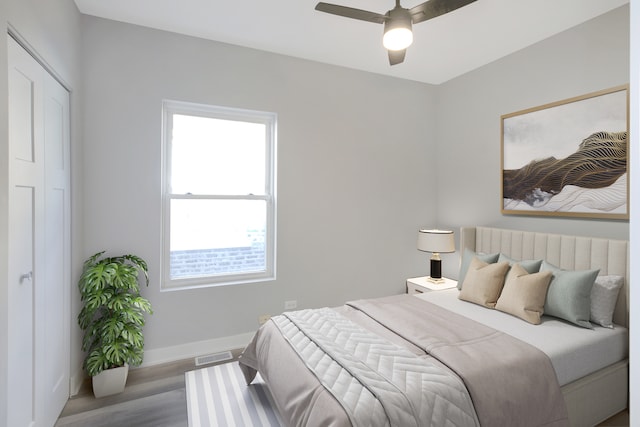 bedroom featuring a closet, wood-type flooring, and ceiling fan