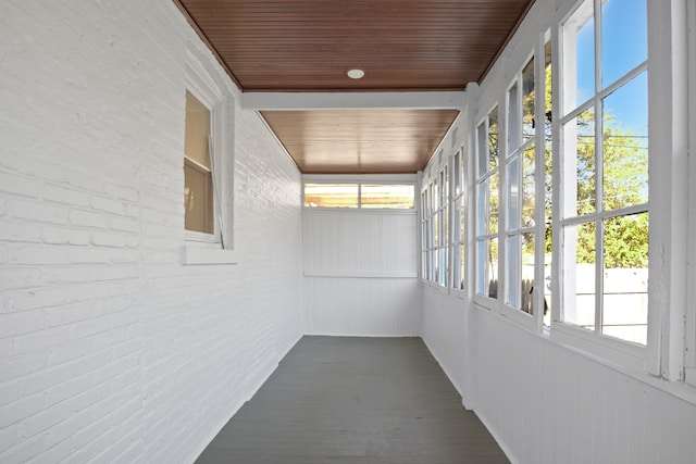 unfurnished sunroom featuring wood ceiling