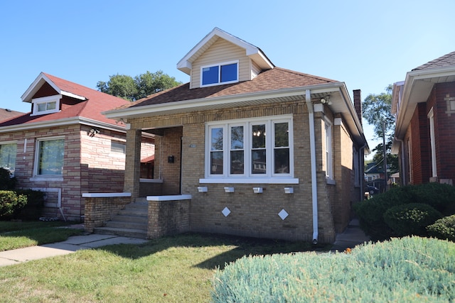 bungalow-style house featuring a front lawn