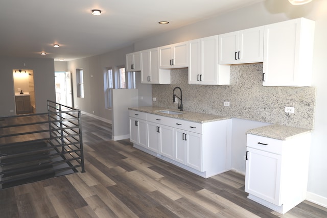 kitchen featuring white cabinets, tasteful backsplash, sink, and dark wood-type flooring