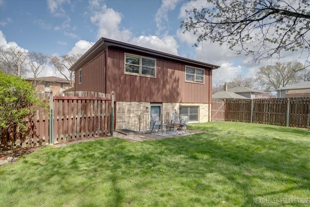 rear view of house with a yard and a patio