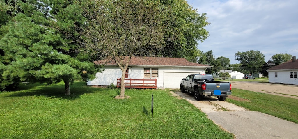 view of front of house with a garage and a front lawn