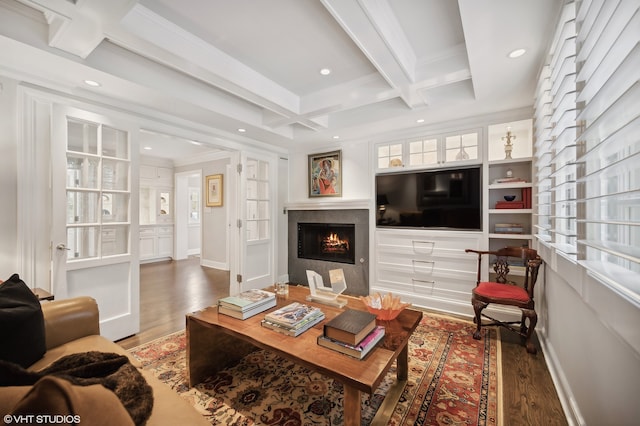 living room with ornamental molding, beam ceiling, coffered ceiling, and dark hardwood / wood-style floors