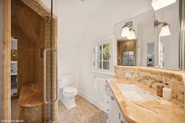 bathroom with backsplash, vanity, tile patterned flooring, toilet, and an enclosed shower