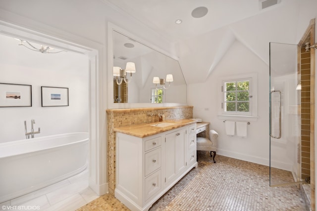 bathroom with plus walk in shower, lofted ceiling, tile patterned flooring, and vanity