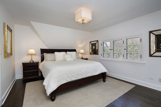 bedroom with ornamental molding and dark wood-type flooring