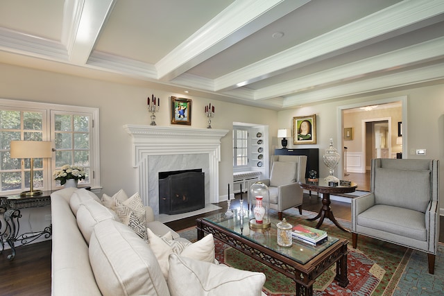 living room featuring beam ceiling, a premium fireplace, dark hardwood / wood-style flooring, and crown molding