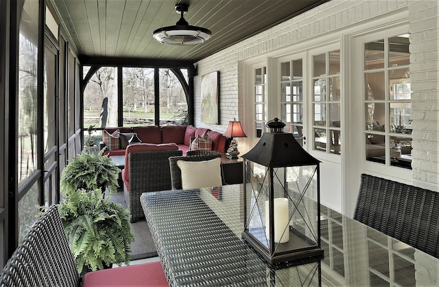 sunroom / solarium featuring wood ceiling