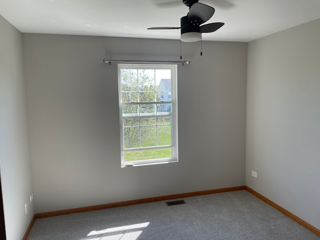 spare room featuring ceiling fan and carpet floors