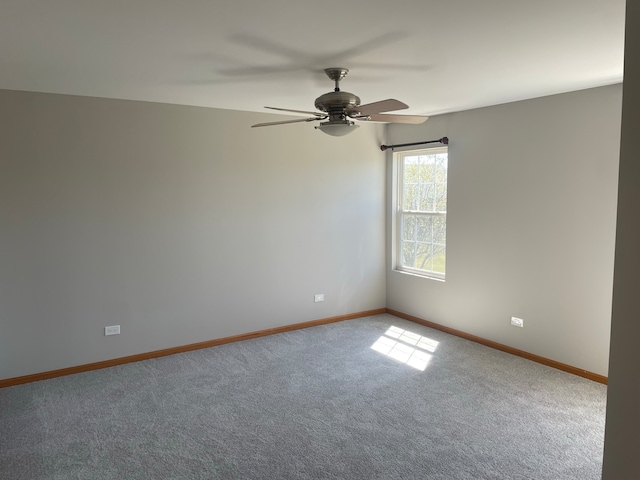 spare room featuring ceiling fan and carpet