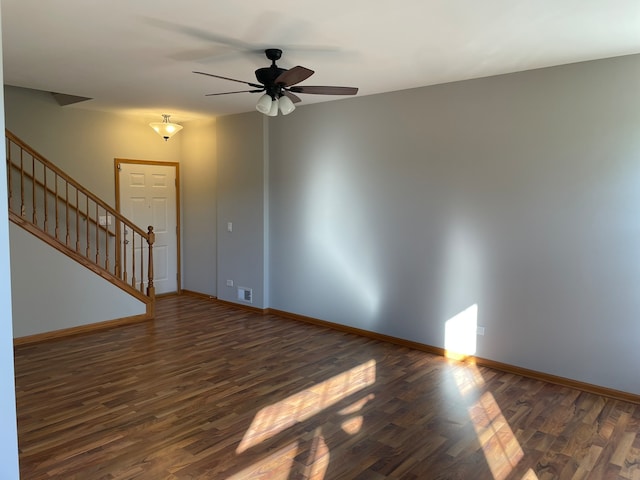 spare room featuring ceiling fan and dark wood-type flooring