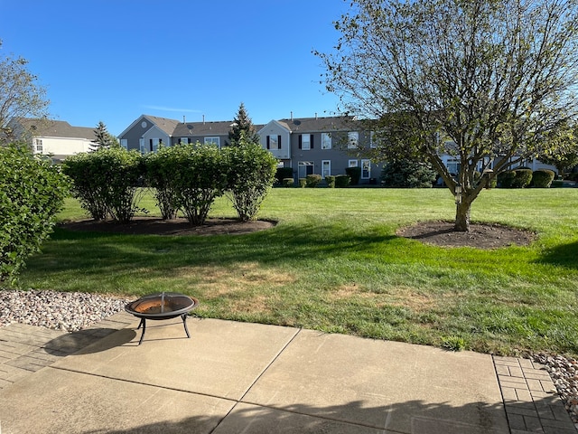 view of yard featuring a fire pit and a patio area