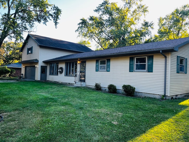 view of front facade with a garage and a front lawn