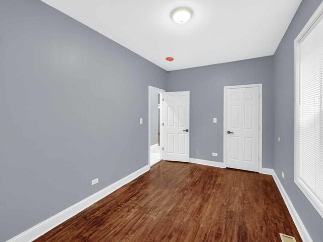 spare room featuring dark wood-type flooring