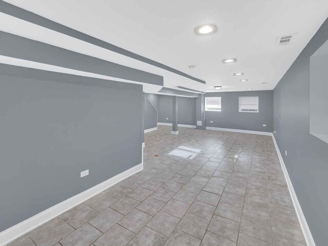 basement featuring light tile patterned flooring