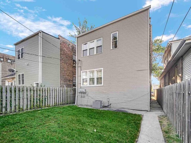 rear view of house featuring a yard