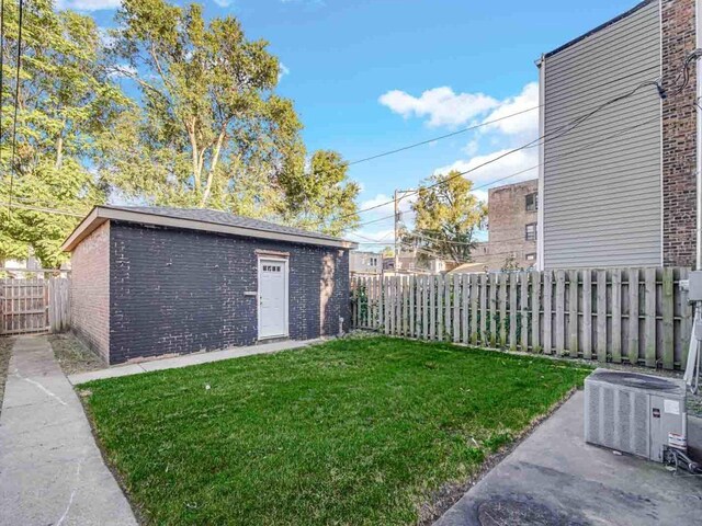 view of yard featuring an outbuilding and central AC unit