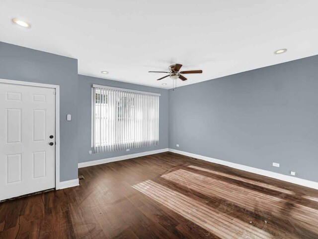 unfurnished room featuring ceiling fan and dark hardwood / wood-style flooring