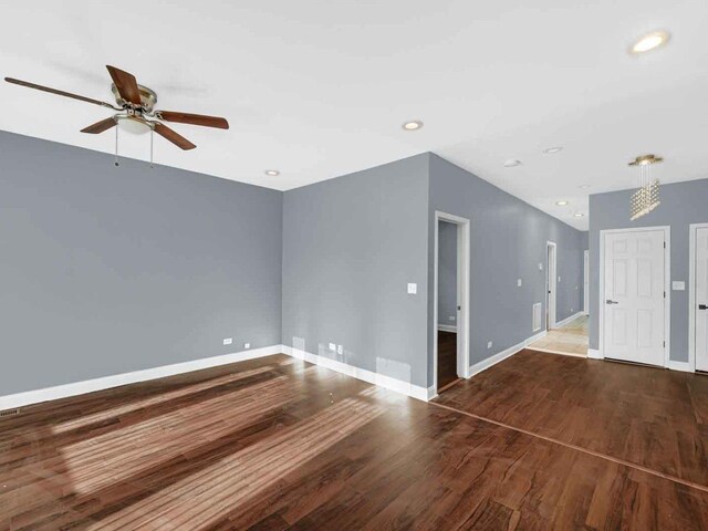 spare room featuring ceiling fan and dark hardwood / wood-style flooring