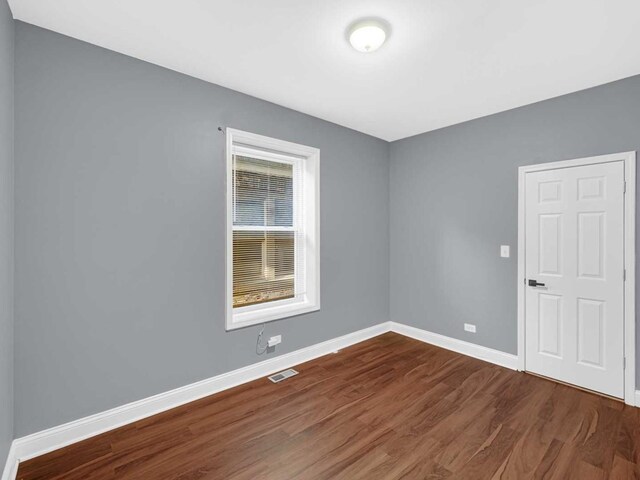 empty room with hardwood / wood-style floors