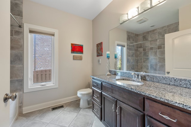 bathroom with tile patterned flooring, vanity, and toilet