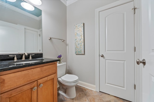 bathroom featuring vanity, toilet, and ornamental molding