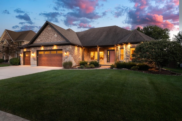 view of front of property featuring a garage and a yard