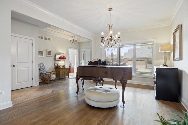 misc room featuring a notable chandelier, wood-type flooring, and crown molding