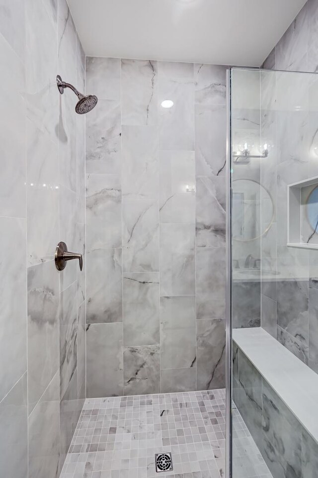 bathroom with a tile shower