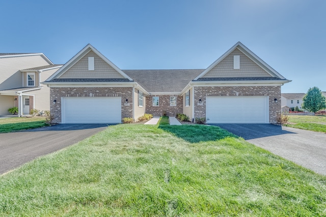 craftsman inspired home featuring a garage and a front lawn