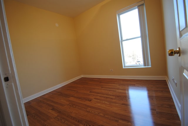 additional living space with dark wood-type flooring