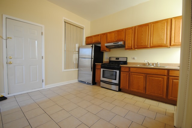 kitchen with light tile patterned flooring, stainless steel appliances, and sink