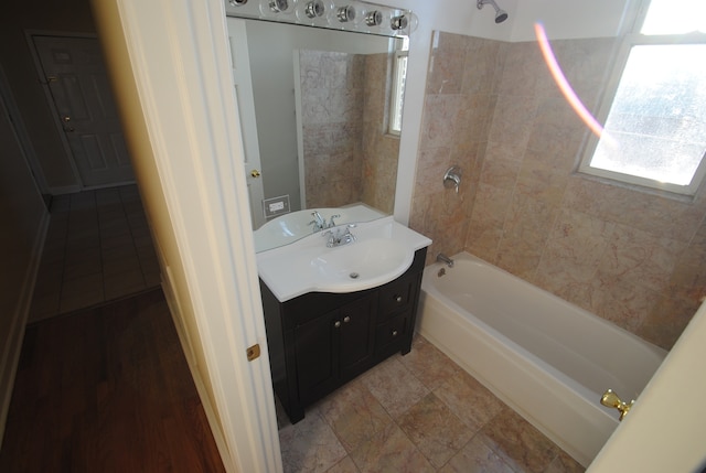 bathroom with vanity and tiled shower / bath