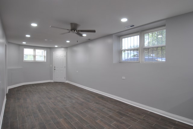 basement with dark wood-type flooring and ceiling fan