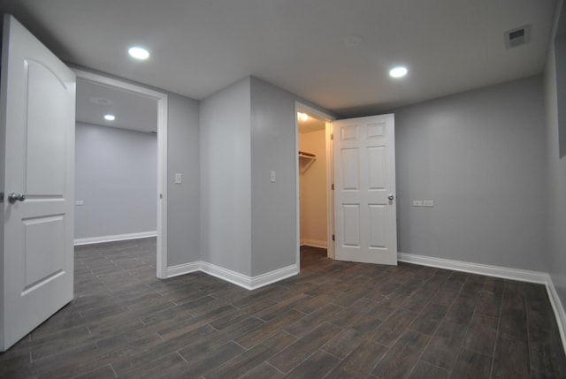 2701 W Congress Pkwy, Chicago, IL 60612 - unfurnished bedroom with a spacious closet, dark wood-style flooring, a closet, and recessed lighting