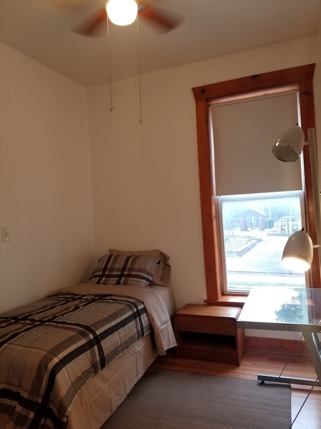 bedroom with ceiling fan and hardwood / wood-style flooring