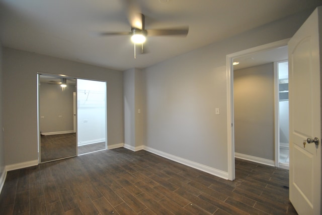 empty room featuring dark wood-type flooring and ceiling fan